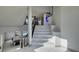 Modern white marble staircase with a game room visible below at 9887 Parador Cellars Ct, Las Vegas, NV 89141