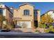 Two-story house with a neutral color scheme and a landscaped front yard at 9936 Coyote Echo Ct, Las Vegas, NV 89166