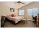 Spacious Primary bedroom with king-size bed and ceiling fan at 2050 Scanlon Ferry Ct # 103, Las Vegas, NV 89156