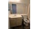 Bathroom with light wood vanity and large mirror at 2108 Panther Pl, North Las Vegas, NV 89031