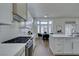 Stylish kitchen with white cabinets, stainless steel appliances, and breakfast bar at 2645 Lotus Hill Dr, Las Vegas, NV 89134