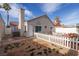 Backyard view of a home with a white picket fence at 2708 Cheshire Ct, Las Vegas, NV 89108