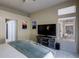 Main bedroom with large TV and access to backyard patio at 2709 Orchid Valley Dr, Las Vegas, NV 89134