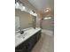 Bathroom with double vanity, quartz countertop, and gray tile at 2800 Wisteria Way, Pahrump, NV 89048