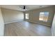 Bright bedroom with large windows, ceiling fan, and hardwood floors at 2800 Wisteria Way, Pahrump, NV 89048