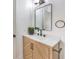 Modern bathroom with wood vanity and a large mirror at 3008 Red Bay Way, Las Vegas, NV 89128