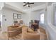 Home office with two comfortable armchairs, a wooden desk, and natural light at 3008 Red Bay Way, Las Vegas, NV 89128