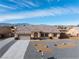 Inviting single-story home boasts a beautifully landscaped front yard and a multi-colored tiled roof at 4800 Honey Locust Dr, Pahrump, NV 89061