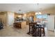 Kitchen and dining area with island seating, dining table, and access to the backyard at 4800 Honey Locust Dr, Pahrump, NV 89061