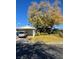 Ranch style home with carport and mature tree in front yard at 5520 Eugene Ave, Las Vegas, NV 89108