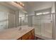 Bathroom with a large walk-in shower and wood vanity at 5899 Lewis Falls Ave, Las Vegas, NV 89139