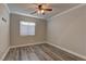 Bright bedroom featuring wood-look floors and a window at 5899 Lewis Falls Ave, Las Vegas, NV 89139