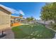 Landscaped backyard featuring a putting green and a spacious lawn at 7200 Rustic Meadow St, Las Vegas, NV 89131