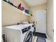 Laundry room with washer, dryer, and shelving for storage at 7200 Rustic Meadow St, Las Vegas, NV 89131