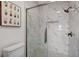 Updated bathroom boasts a marble tiled shower, white toilet, and wall art at 7400 W Flamingo Rd # 1006, Las Vegas, NV 89147