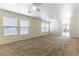 Bright living room with neutral carpet, ceiling fans and window blinds at 8445 Lost Gold Ave, Las Vegas, NV 89129