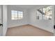 Well-lit bedroom featuring neutral carpeting and dual windows at 8645 Edmond St, Las Vegas, NV 89139