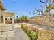 Landscaped backyard with covered patio and gravel at 9609 Rolling Thunder Ave, Las Vegas, NV 89148