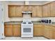 Kitchen with white appliances and wood cabinets at 9609 Rolling Thunder Ave, Las Vegas, NV 89148