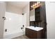 Modern bathroom with white tiled walls, a soaking tub, and dark wood vanity at 2151 Hussium Hills St # 207, Las Vegas, NV 89108