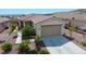 Single-story home with a two-car garage and landscaped yard at 2351 Thornwood Castle Dr, Laughlin, NV 89029