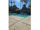 Community pool with a surrounding patio and lounge chairs at 240 Mission Catalina Ln # 204, Las Vegas, NV 89107