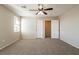 Bedroom featuring carpet, ceiling fan, and two adjacent doors at 2517 Madre Grande St, Las Vegas, NV 89142