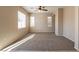 Spacious, carpeted living room with a ceiling fan and natural light at 2517 Madre Grande St, Las Vegas, NV 89142