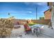 Landscaped backyard with patio furniture and fire pit at 4200 Tolkien Ave, Las Vegas, NV 89115