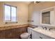 Updated bathroom with a white vanity and dark brown tile at 4200 Tolkien Ave, Las Vegas, NV 89115