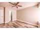 Bedroom with ceiling fan, wood-look floors and walk-in closet at 4200 Tolkien Ave, Las Vegas, NV 89115