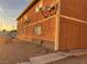 Side view of a multi-unit residential building with satellite dishes and a gravel side yard at 4705 Lucite Ln, Las Vegas, NV 89115