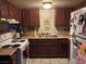 Compact kitchen with dark wood cabinets, white appliances, and ample counter space at 4705 Lucite Ln, Las Vegas, NV 89115