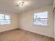 Bright bedroom with two windows, light walls, and light wood-look flooring at 5750 Edna Ave, Las Vegas, NV 89146