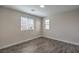 Well-lit bedroom featuring wood-look floors and window blinds at 6608 Fort William St, North Las Vegas, NV 89084