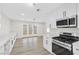 Modern kitchen with white cabinets, stainless steel appliances and access to backyard at 6624 Fredonia Dr, Las Vegas, NV 89108