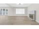 Spacious living room with wood-look floors, fireplace, and access to backyard at 6624 Fredonia Dr, Las Vegas, NV 89108