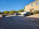 Two cars parked in a lot near a tan building at 85 Day Trade St # 2, Henderson, NV 89074