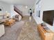 Bright living room with tiled floors, staged furniture, and a staircase at 8873 Stallings St, Las Vegas, NV 89148