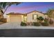 Single-story home with a two-car garage and desert landscaping at 1905 Crown Lodge Ln, North Las Vegas, NV 89084