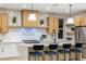 Modern kitchen with light wood cabinets, quartz countertops, and a large island at 1905 Crown Lodge Ln, North Las Vegas, NV 89084