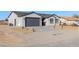 Single-story house with gray exterior, two-car garage, and landscaping at 2070 Idaho St, Pahrump, NV 89048