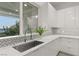 Modern kitchen sink and faucet with white cabinets and herringbone backsplash at 31 Vista Outlook St, Henderson, NV 89011