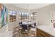 Breakfast nook with a round table and blue leather chairs, bathed in sunlight at 3110 Scotts Valley Dr, Henderson, NV 89052