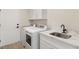 Laundry room with modern washer, dryer, and white cabinets at 3110 Scotts Valley Dr, Henderson, NV 89052