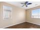 Bedroom with wood floors, ceiling fan and window at 324 Trailing Putt Way, Las Vegas, NV 89148