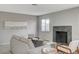 Living room with fireplace, gray sofa and wood accent chairs at 3700 Edison Ave, Las Vegas, NV 89121