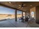 Covered patio with seating area, ceiling fan, and views of the backyard at 3780 Shawnee Ave, Pahrump, NV 89048