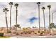 Community entrance with palm trees and signage at 400 Mill Hollow Rd, Las Vegas, NV 89107