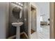 Small bathroom with pedestal sink and gray walls at 6564 Sweetzer Way, Las Vegas, NV 89108